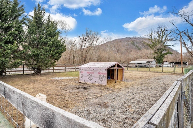 view of yard featuring a mountain view and an outdoor structure