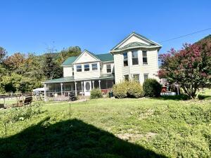 back of house with a lawn