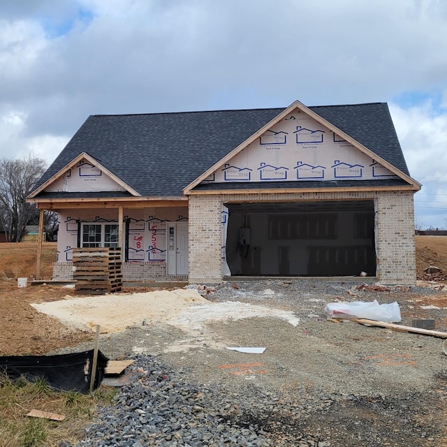 unfinished property featuring a porch and a garage