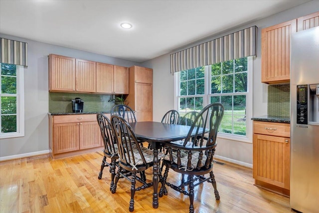 dining space with light hardwood / wood-style floors and plenty of natural light