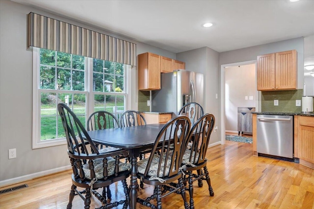 dining space with light wood-type flooring