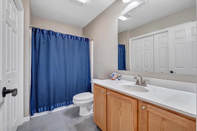 bathroom featuring curtained shower, vanity, and toilet