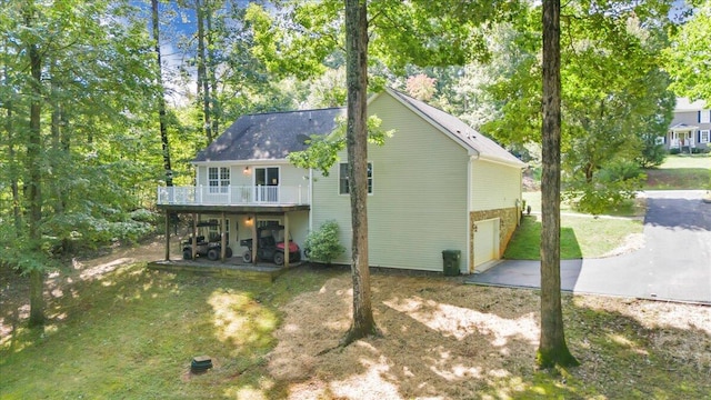 view of home's exterior with a balcony and a garage