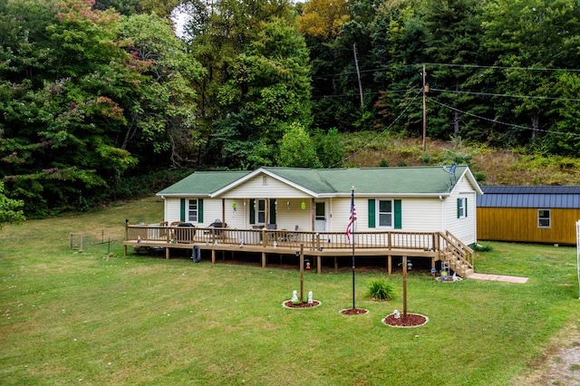 view of front of property with a deck and a front lawn