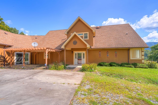 1782 Wolf Creek Rd, Narrows, VA 24124 - view of front of property with a pergola, stucco siding, and a front lawn