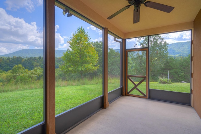 1782 Wolf Creek Rd, Narrows, VA 24124 - unfurnished sunroom with a ceiling fan, a mountain view, and plenty of natural light