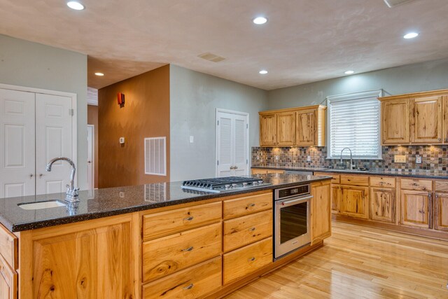 1782 Wolf Creek Rd, Narrows, VA 24124 - kitchen with stainless steel appliances, a sink, recessed lighting, light wood-style floors, and decorative backsplash