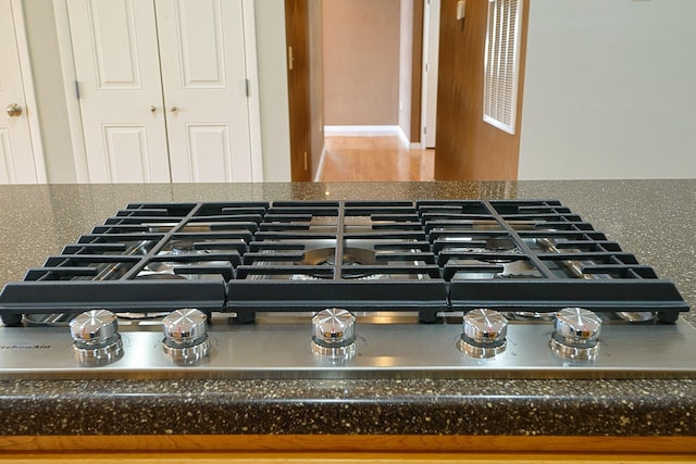 1782 Wolf Creek Rd, Narrows, VA 24124 - detailed view of stainless steel gas stovetop and dark countertops