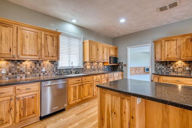 1782 Wolf Creek Rd, Narrows, VA 24124 - kitchen featuring stainless steel dishwasher, a sink, light wood-style floors, decorative backsplash, and recessed lighting
