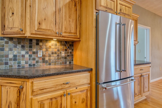 1782 Wolf Creek Rd, Narrows, VA 24124 - kitchen with high end fridge, backsplash, light wood finished floors, baseboards, and dark stone countertops