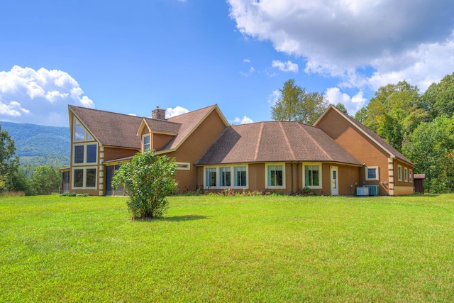 1782 Wolf Creek Rd, Narrows, VA 24124 - back of house with a lawn, a chimney, and central AC unit