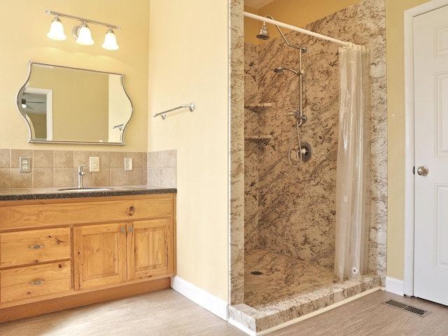 1782 Wolf Creek Rd, Narrows, VA 24124 - bathroom with a shower stall, vanity, decorative backsplash, and wood finished floors
