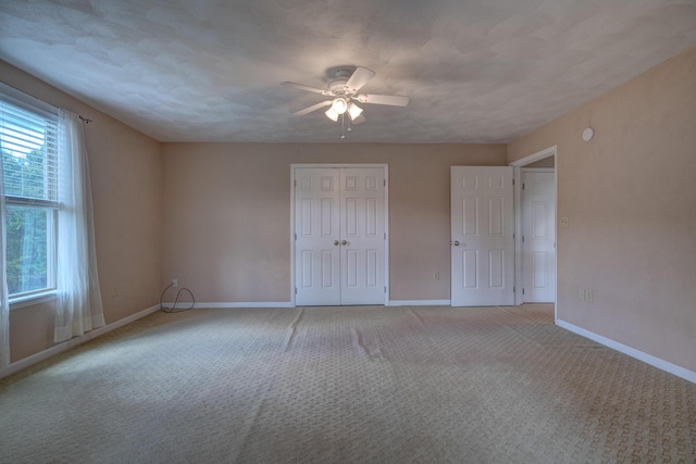 1782 Wolf Creek Rd, Narrows, VA 24124 - unfurnished bedroom with baseboards, light carpet, a closet, and a ceiling fan