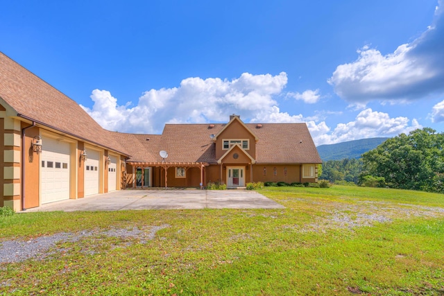 1782 Wolf Creek Rd, Narrows, VA 24124 - view of front facade featuring a front lawn, concrete driveway, an attached garage, and a mountain view