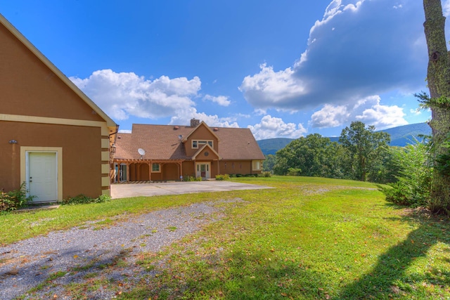 1782 Wolf Creek Rd, Narrows, VA 24124 - view of green lawn with a patio area and a mountain view
