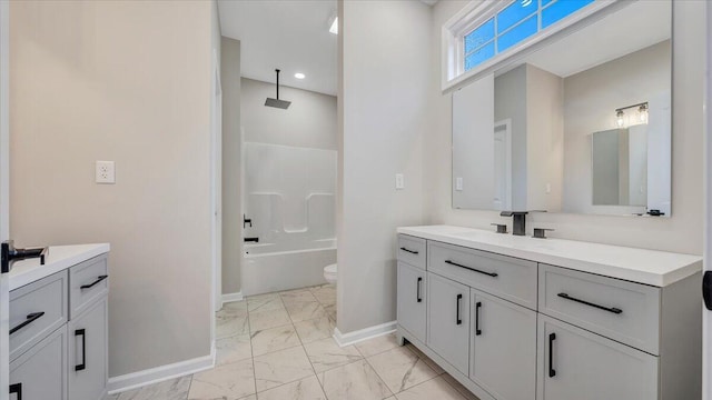 full bathroom featuring baseboards, toilet, a combined bath / shower with rainfall shower, marble finish floor, and vanity