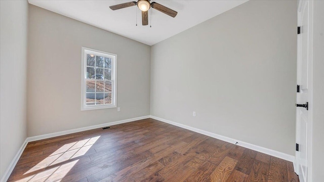 empty room with dark wood-style flooring, visible vents, ceiling fan, and baseboards