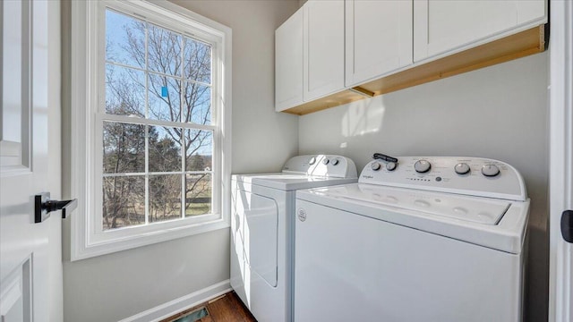 laundry area featuring cabinet space, washing machine and dryer, and baseboards