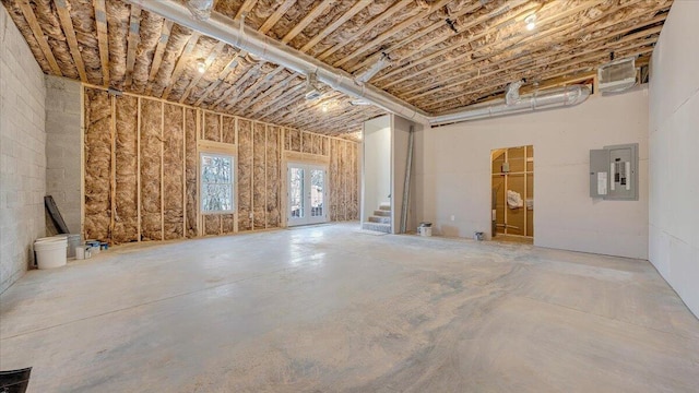 misc room featuring electric panel and unfinished concrete floors