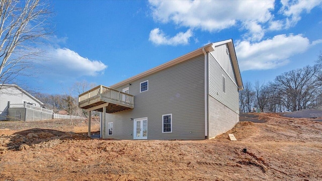 back of house featuring french doors and a wooden deck