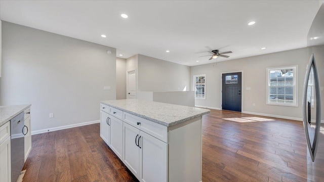 kitchen with light stone counters, recessed lighting, white cabinetry, open floor plan, and dark wood-style floors