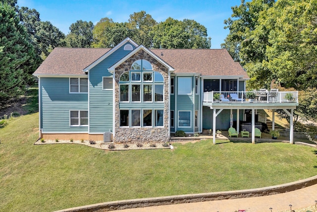 back of house featuring a yard, a wooden deck, and cooling unit