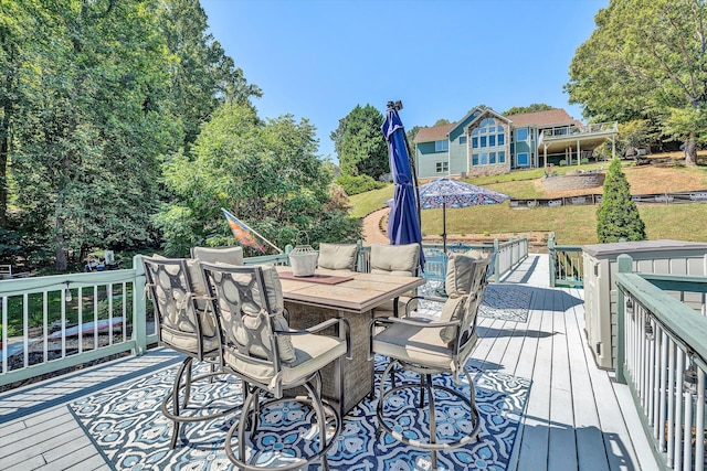 wooden deck featuring a lawn