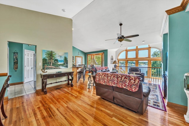 bedroom with light hardwood / wood-style flooring, ceiling fan, and high vaulted ceiling