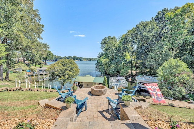 view of patio with a water view and a fire pit