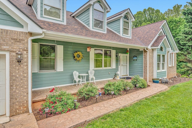 900 Lakemount Dr, Moneta, VA 24121 - new england style home featuring a porch, roof with shingles, and a front lawn