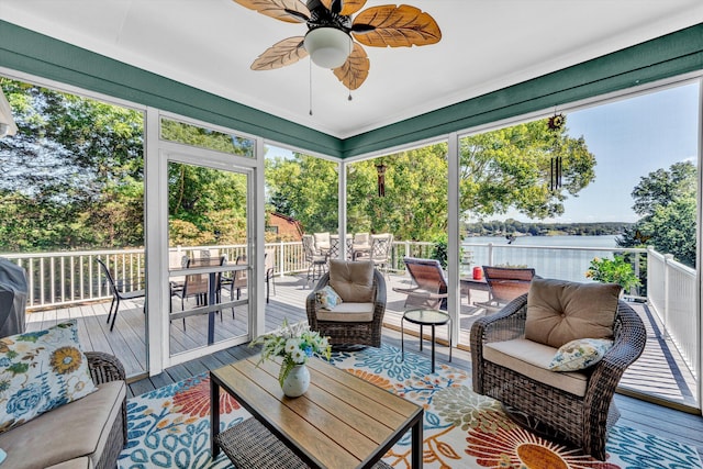 sunroom with a water view, ceiling fan, and plenty of natural light