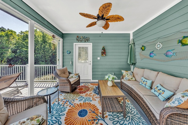 sunroom featuring ceiling fan