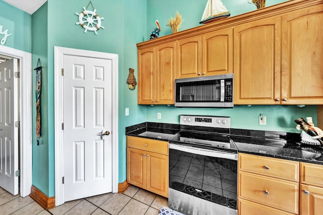 900 Lakemount Dr, Moneta, VA 24121 - kitchen with appliances with stainless steel finishes, light tile patterned floors, light brown cabinetry, and baseboards