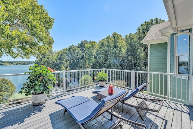 wooden terrace featuring a water view