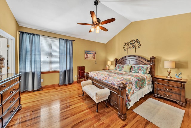 bedroom with ceiling fan, vaulted ceiling, and light hardwood / wood-style flooring