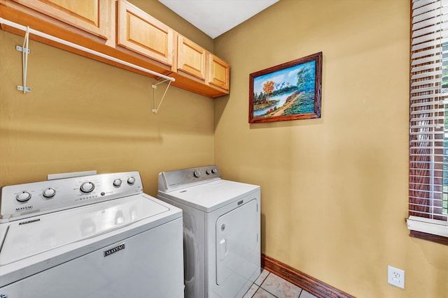 washroom with light tile patterned floors, cabinets, and separate washer and dryer