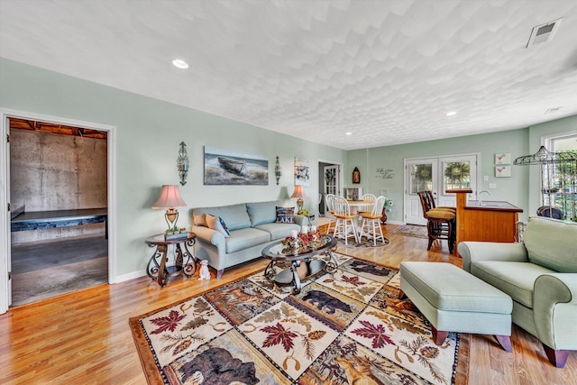 living room featuring a textured ceiling and hardwood / wood-style flooring