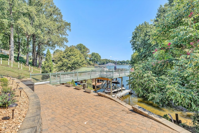 view of patio / terrace with a dock and a water view