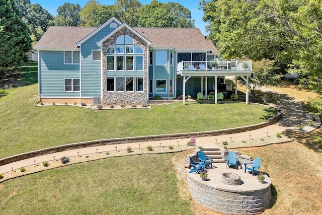 back of house featuring a fire pit, a lawn, central AC, and a patio area