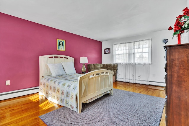 bedroom featuring hardwood / wood-style flooring and a baseboard radiator