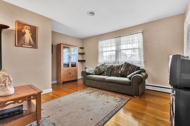 living room featuring light hardwood / wood-style floors and baseboard heating