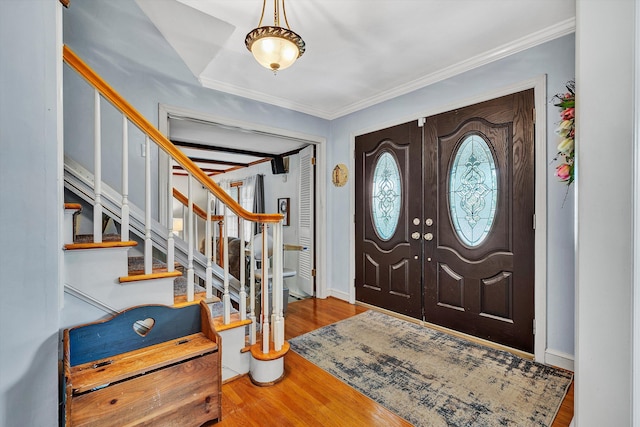 foyer entrance featuring wood-type flooring and ornamental molding