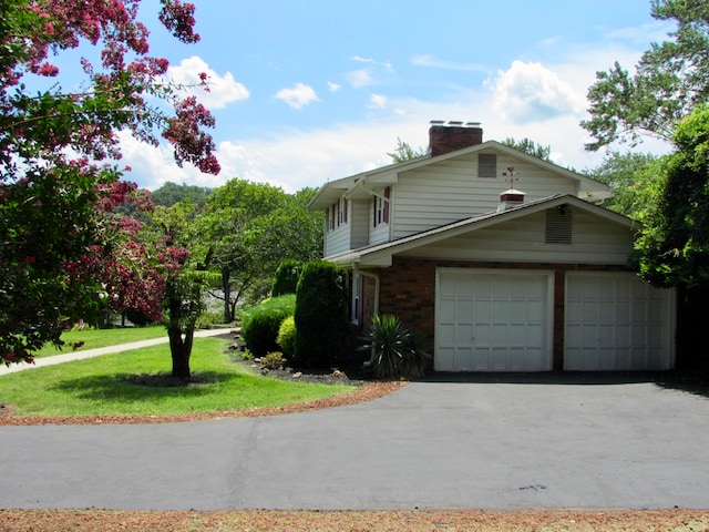 view of property exterior with a garage and a lawn