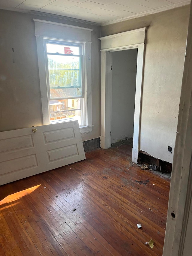 entryway with ornamental molding and dark wood-type flooring