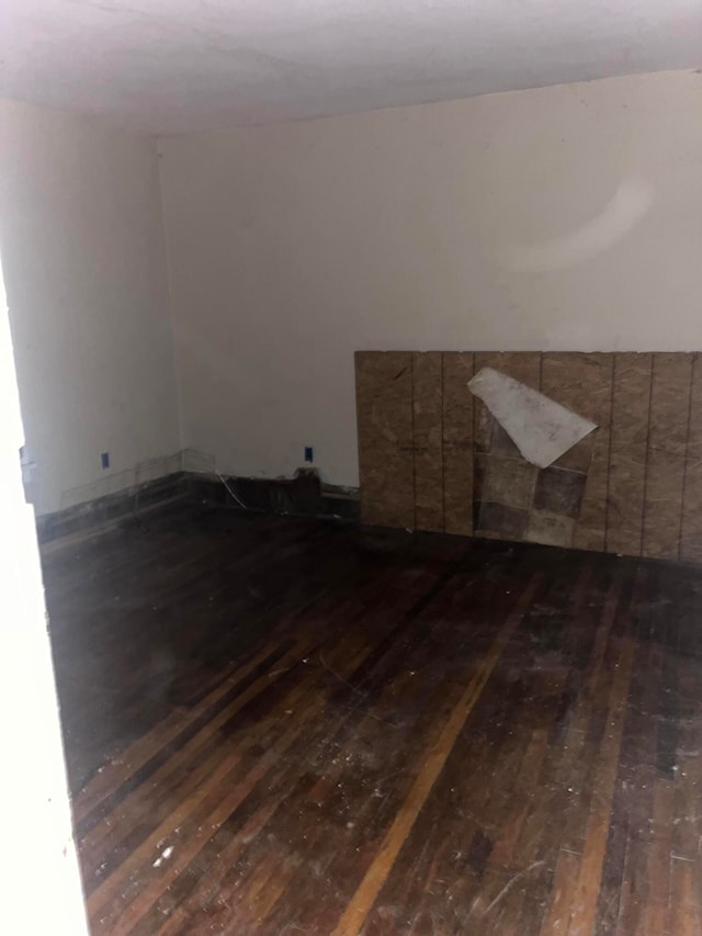 empty room featuring dark hardwood / wood-style flooring