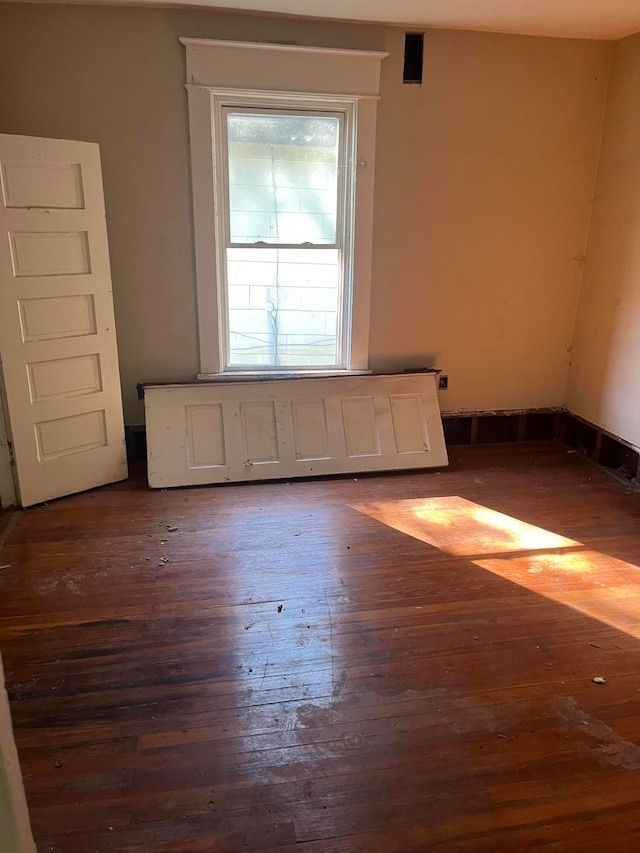 empty room featuring dark wood-type flooring