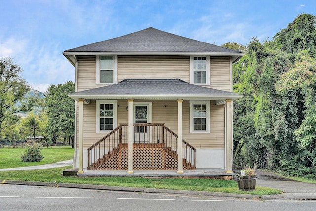 view of property with a front lawn and covered porch