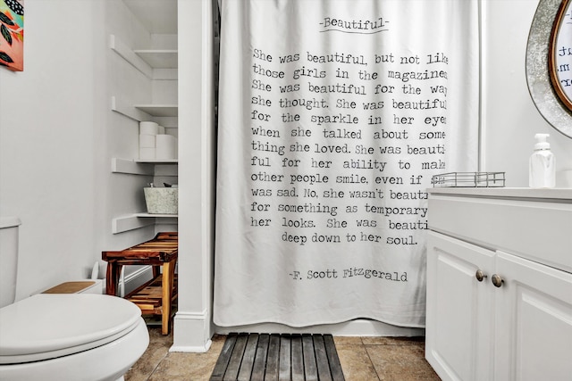 bathroom featuring a shower with curtain, vanity, tile patterned flooring, and toilet