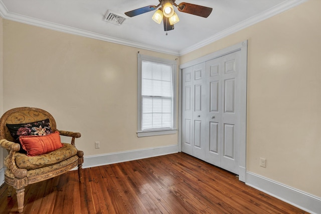 sitting room featuring ornamental molding, dark hardwood / wood-style floors, and ceiling fan