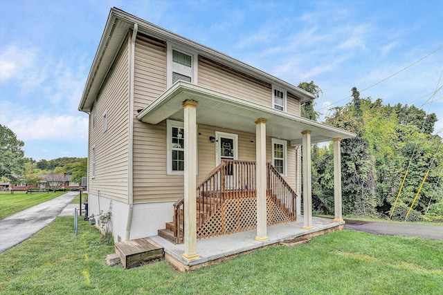 view of front of home with a front yard and covered porch